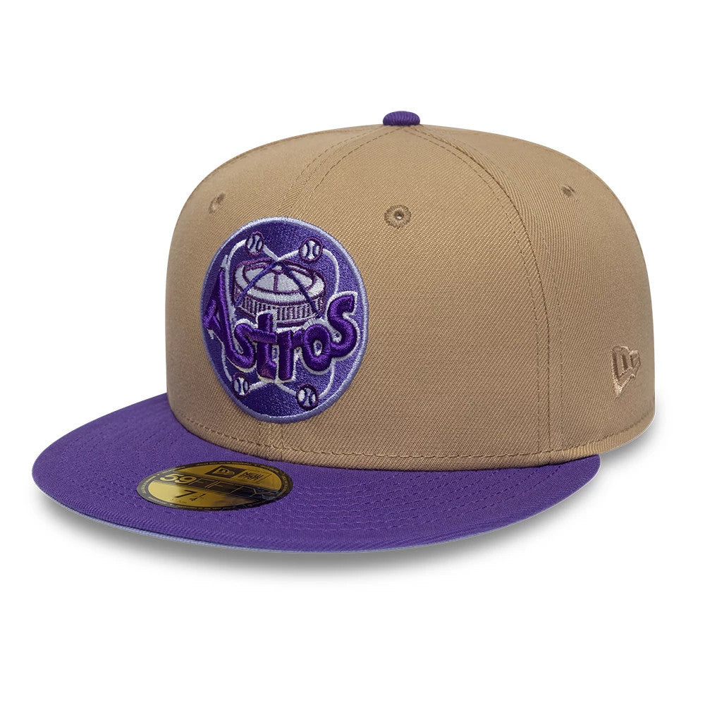 Houston Astros MLB Cooperstown Beige New Era 59FIFTY Fitted Cap, three-quarter view showing a purple and lavender embroidered Astros logo on the front panel, a purple flat visor with a gold 59FIFTY size sticker.