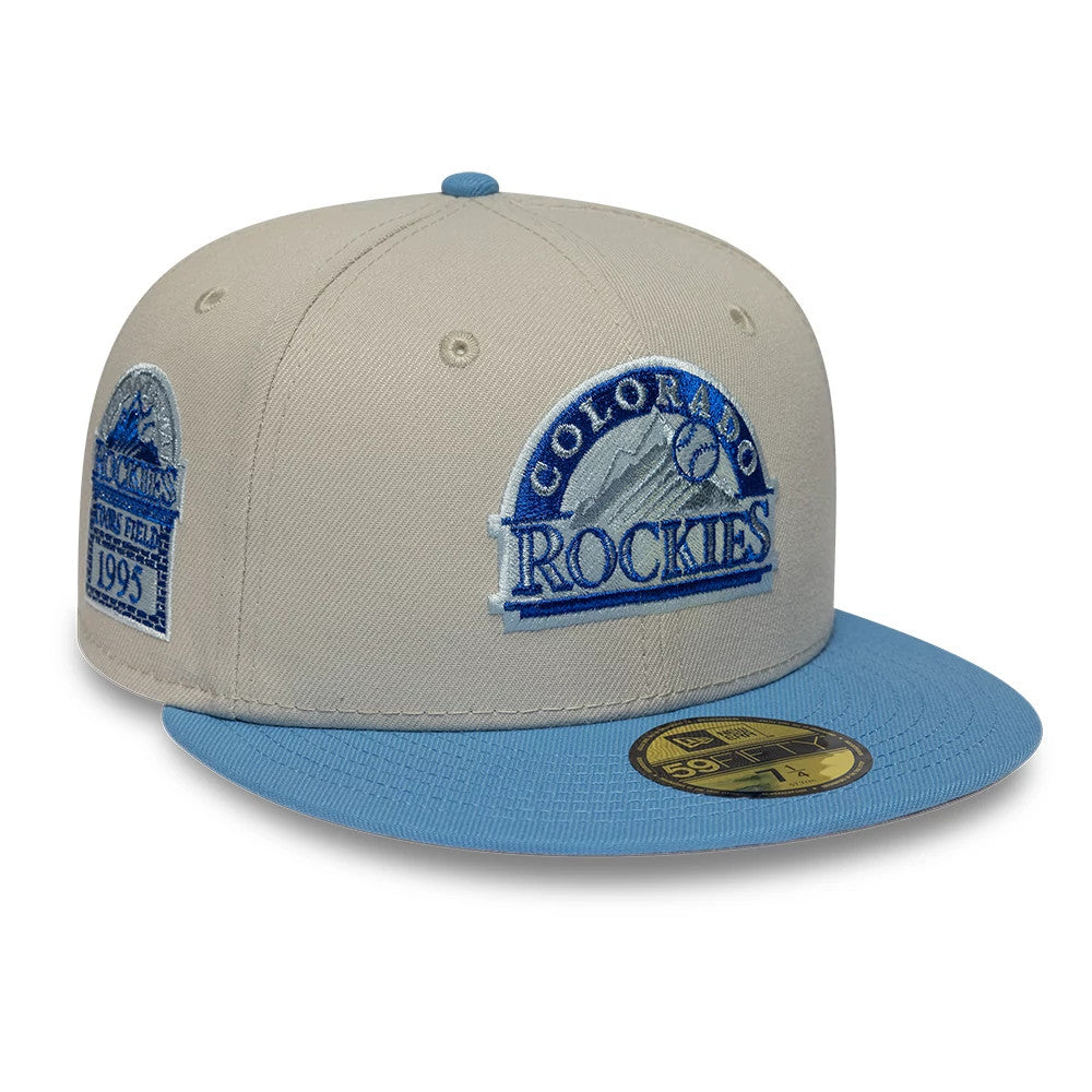 Colorado Rockies MLB Cooperstown Cream New Era 59FIFTY Fitted Cap, front view showing the blue embroidered team logo on the cream front panel, a sky blue flat visor with a gold 59FIFTY size sticker, and a side patch Coors Field 1995.