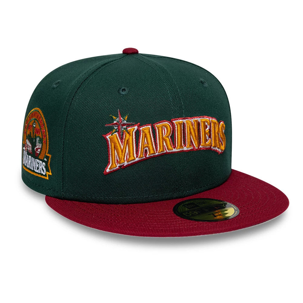 Seattle Mariners MLB Cooperstown Dark Green New Era 59FIFTY Fitted Cap, three-quarter view showing the large yellow and red embroidered Mariners logo on the front panels, burgundy flat visor with a gold 59FIFTY size sticker, and side patch detail.