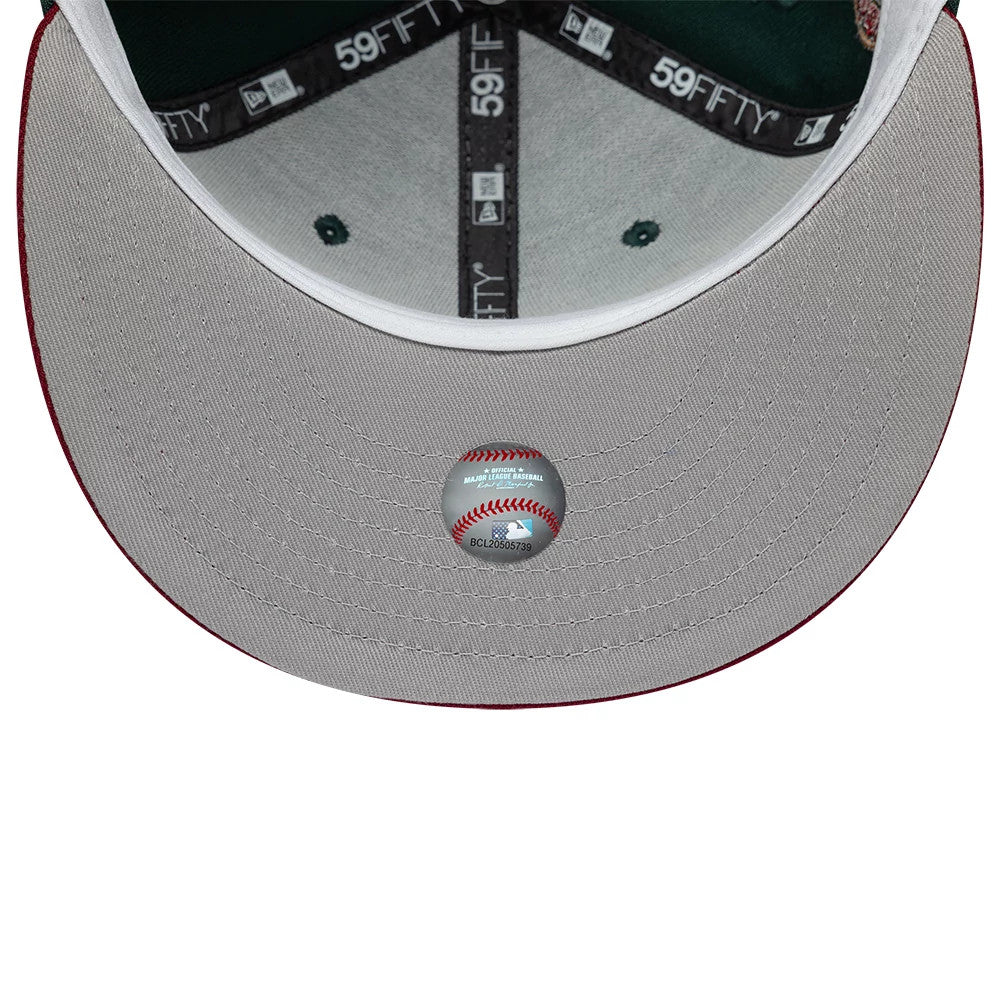 Seattle Mariners MLB Cooperstown Dark Green New Era 59FIFTY Fitted Cap, inside view showing dark grey taping with 59FIFTY logos, a green undervisor, a white sweatband, and a baseball graphic sticker placed centrally at the top of the grey visor.