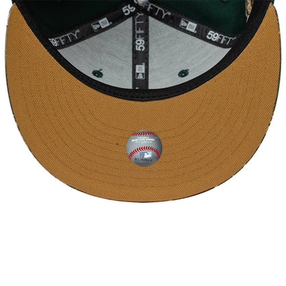 Houston Astros MLB Cooperstown Green New Era 59FIFTY Fitted Cap, inside view showing the grey undervisor featuring a small baseball graphic decal, black internal taping with repeated 59FIFTY branding.
