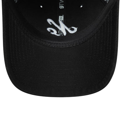 New Era Black 9TWENTY Adjustable Cap, inside view showing a white embroidered design on the black undervisor, black taping with 9TWENTY logos printed in grey, and a black sweatband with stitching.