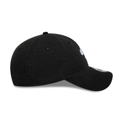 New Era Black 9TWENTY Adjustable Cap, side view showing the curved visor with silver 9TWENTY size sticker, embroidered eyelets on the unstructured black crown, and front logo stitching.