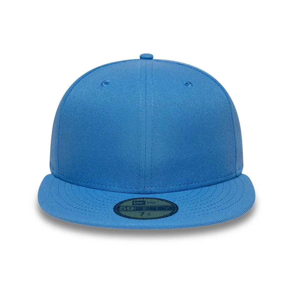 New Era Blue 59FIFTY Fitted Cap, front view showing the flat blue visor and blue top button, with a gold 59FIFTY size sticker on the visor, emphasising the solid blue colour of the structured crown.