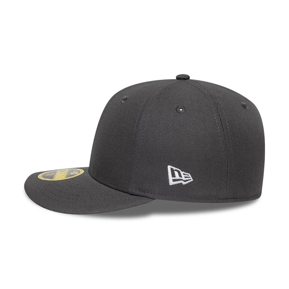 New Era Grey Low Profile 59FIFTY Fitted Cap, side view showing the white embroidered New Era flag logo on the left side panel, with a structured grey crown, curved visor, and a gold 59FIFTY size sticker on the visor.