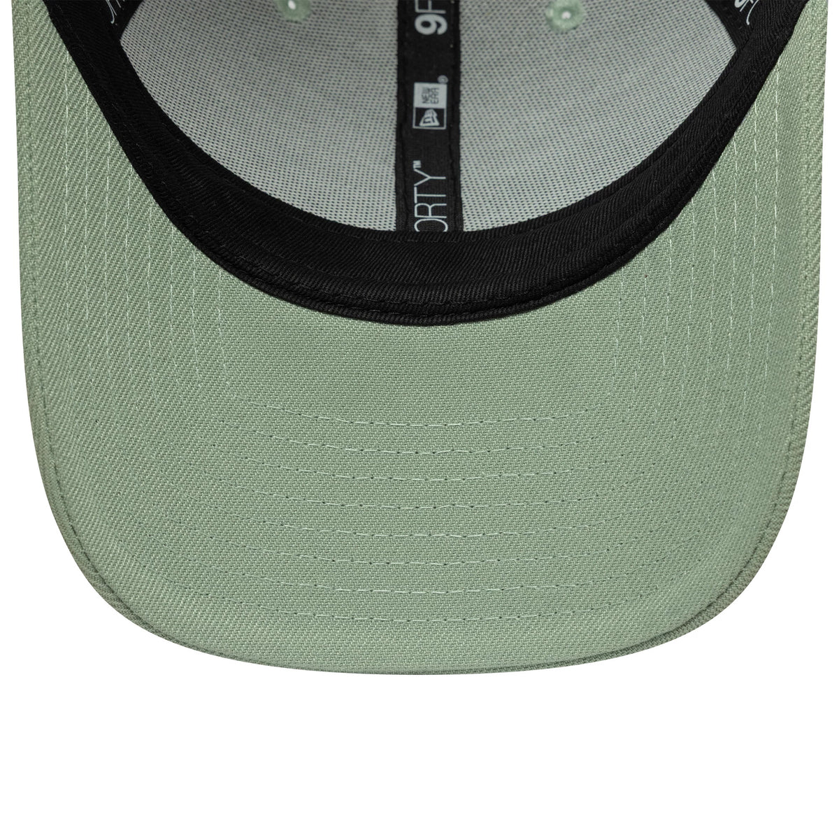 New Era Green 9FORTY Trucker Adjustable Cap, inside view showing the light green undervisor contrasted by a black sweatband, and interior taping marked with 9FORTY branding, offering an insight into the cap's structure with stitching.
