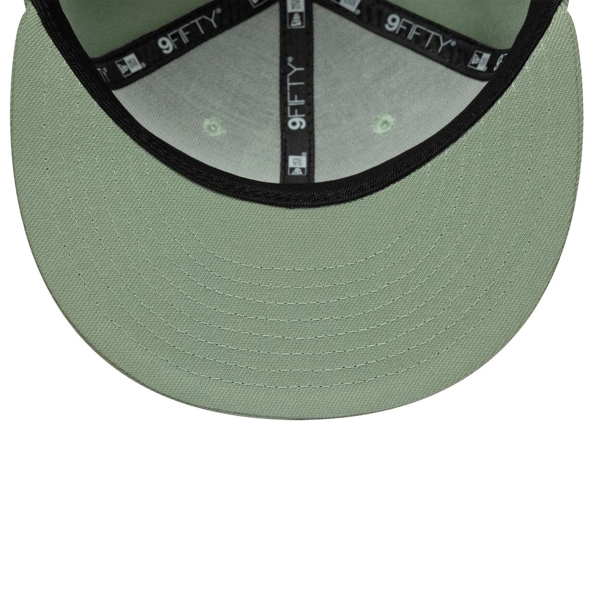New Era Green 9FIFTY Snapback Adjustable Cap, inside view showing the black 9FIFTY taping along the seams, light green undervisor with detailed stitching, and matching fabric panels with a green tone under each eyelet for a cohesive look.