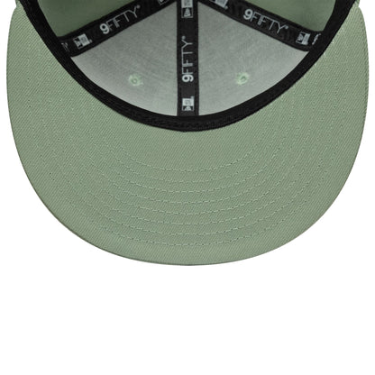New Era Green 9FIFTY Snapback Adjustable Cap, inside view showing the black 9FIFTY taping along the seams, light green undervisor with detailed stitching, and matching fabric panels with a green tone under each eyelet for a cohesive look.