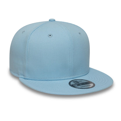 New Era Blue 9FIFTY Snapback Adjustable Cap, front view showing a flat blue visor with a 9FIFTY size sticker, eyelets on the structured crown, and a top button in matching blue fabric for a cohesive look.