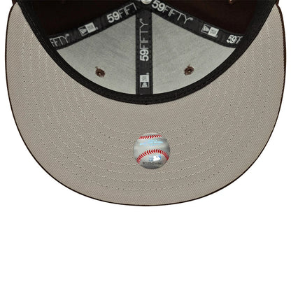 New York Yankees MLB Dark Brown New Era 59FIFTY Fitted Cap, inside view showing black taping with 59FIFTY branding, a grey sweatband, and a baseball sticker on the khaki undervisor, providing detailed craftsmanship and design elements inside the cap.