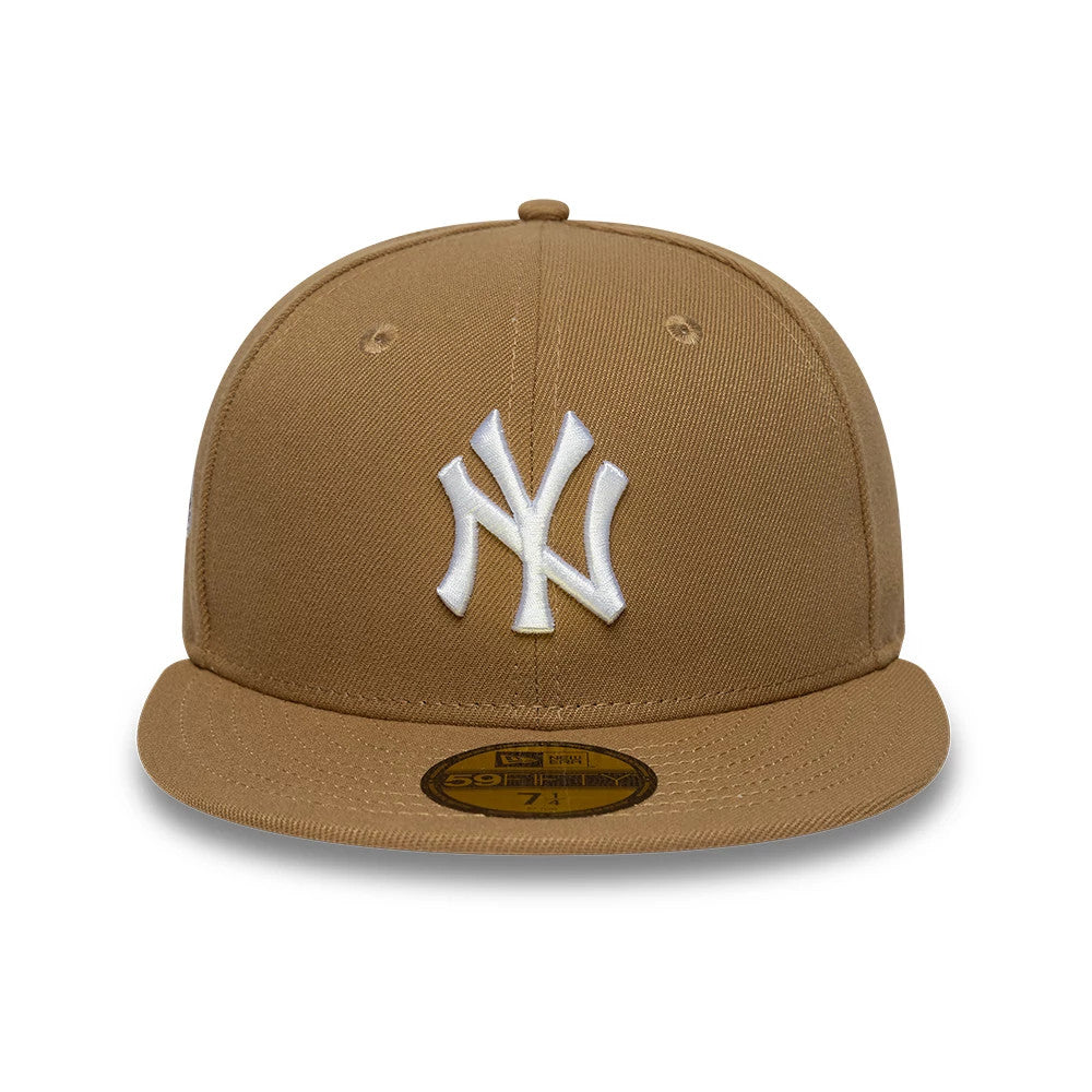 New York Yankees MLB Beige New Era 59FIFTY Fitted Cap, front view showing the raised white NY logo embroidered on the structured beige crown, with a flat beige visor and a gold 59FIFTY size sticker on the visor.