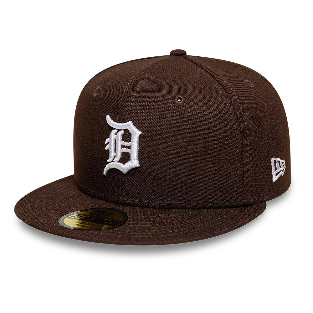 Detroit Tigers MLB Dark Brown New Era 59FIFTY Fitted Cap, three-quarter view showing the white embroidered Old English D logo on the front panel, a gold 59FIFTY size sticker on the flat dark brown visor, and New Era flag logo on the left side.