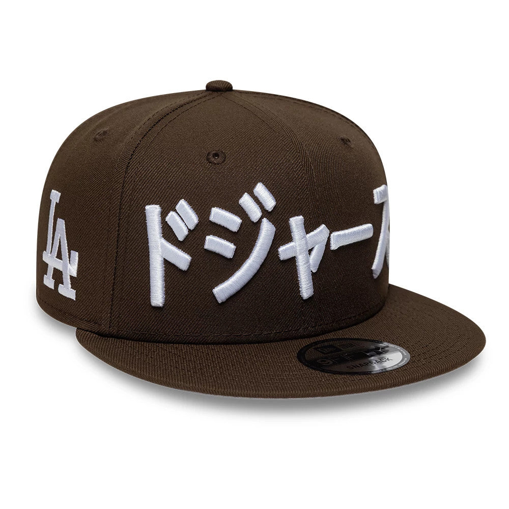 Pictured is this MLB Kanji LA Dodgers 9FIFTY Snapback Adjustable cap in dark brown. 1