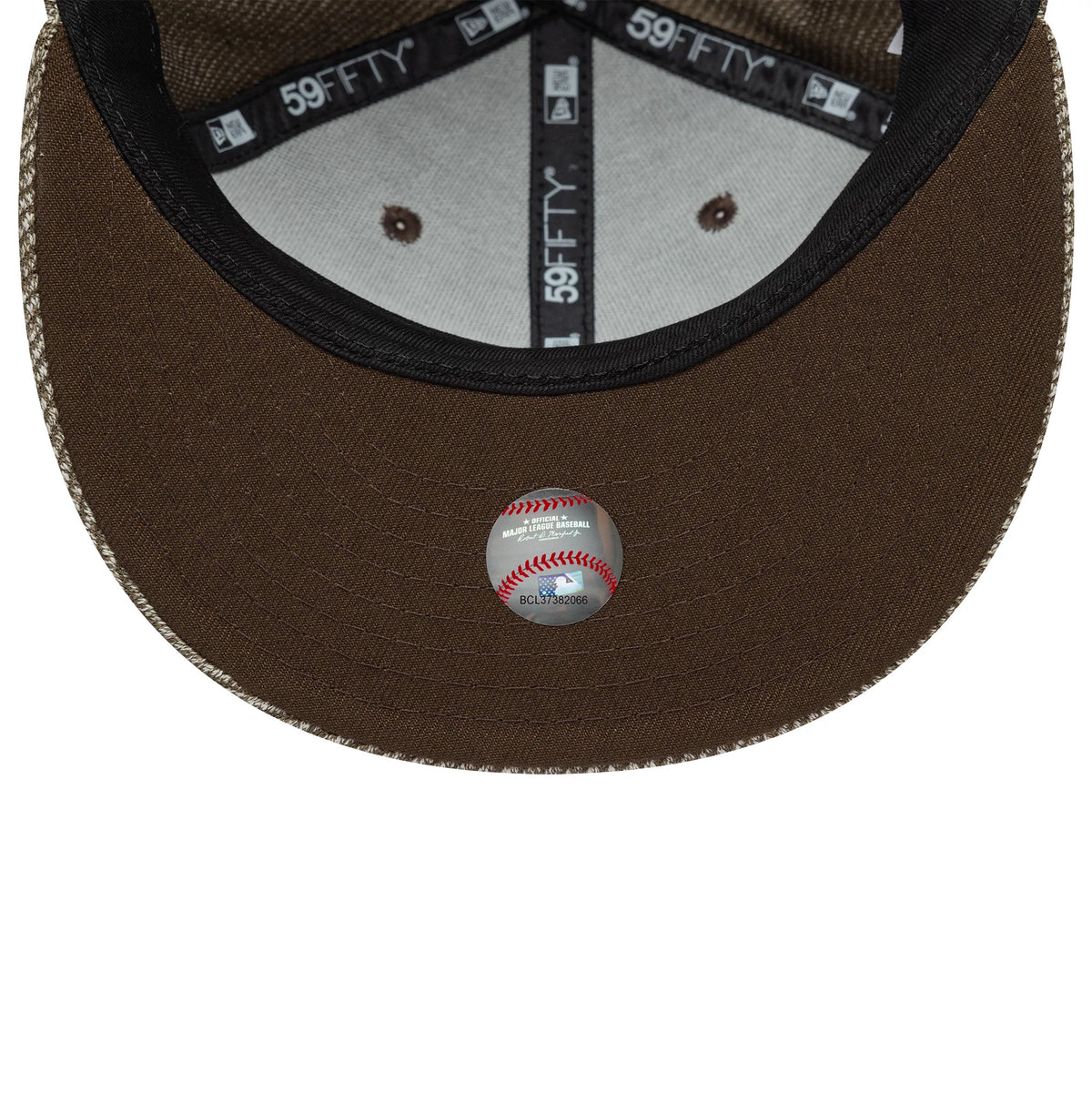 New York Yankees MLB Heather Brown New Era 59FIFTY Fitted Cap, inside view showing black 59FIFTY taping, a grey sweatband, and a dark brown undervisor with a baseball graphic sticker centrally placed.
