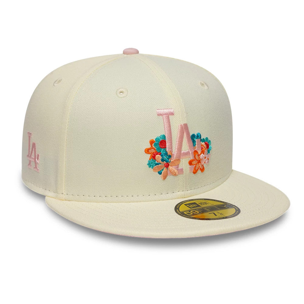 LA Dodgers MLB Floral Cream New Era 59FIFTY Fitted Cap, front view showing pastel pink embroidered LA logo surrounded by colourful floral designs on the front panel, with a flat cream visor and a gold 59FIFTY size sticker.