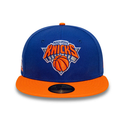 Pictured is this NBA Champs 2025 - 2026 New York Knicks 59FIFTY Fitted cap in blue and orange. 3