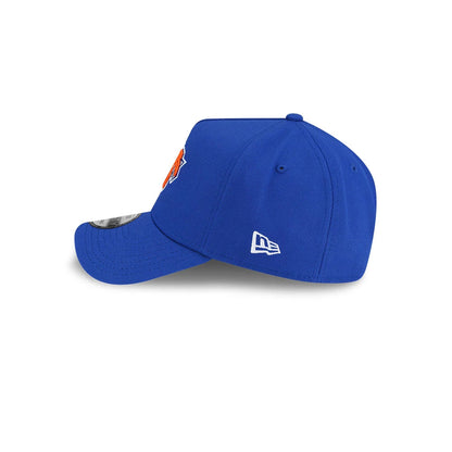 New York Knicks NBA Champs 2025 - 2026 Blue New Era 9FORTY A-Frame Adjustable Cap, side view showing the white New Era flag logo on the left side of a structured blue crown, with curved visor and a 9FORTY size sticker.