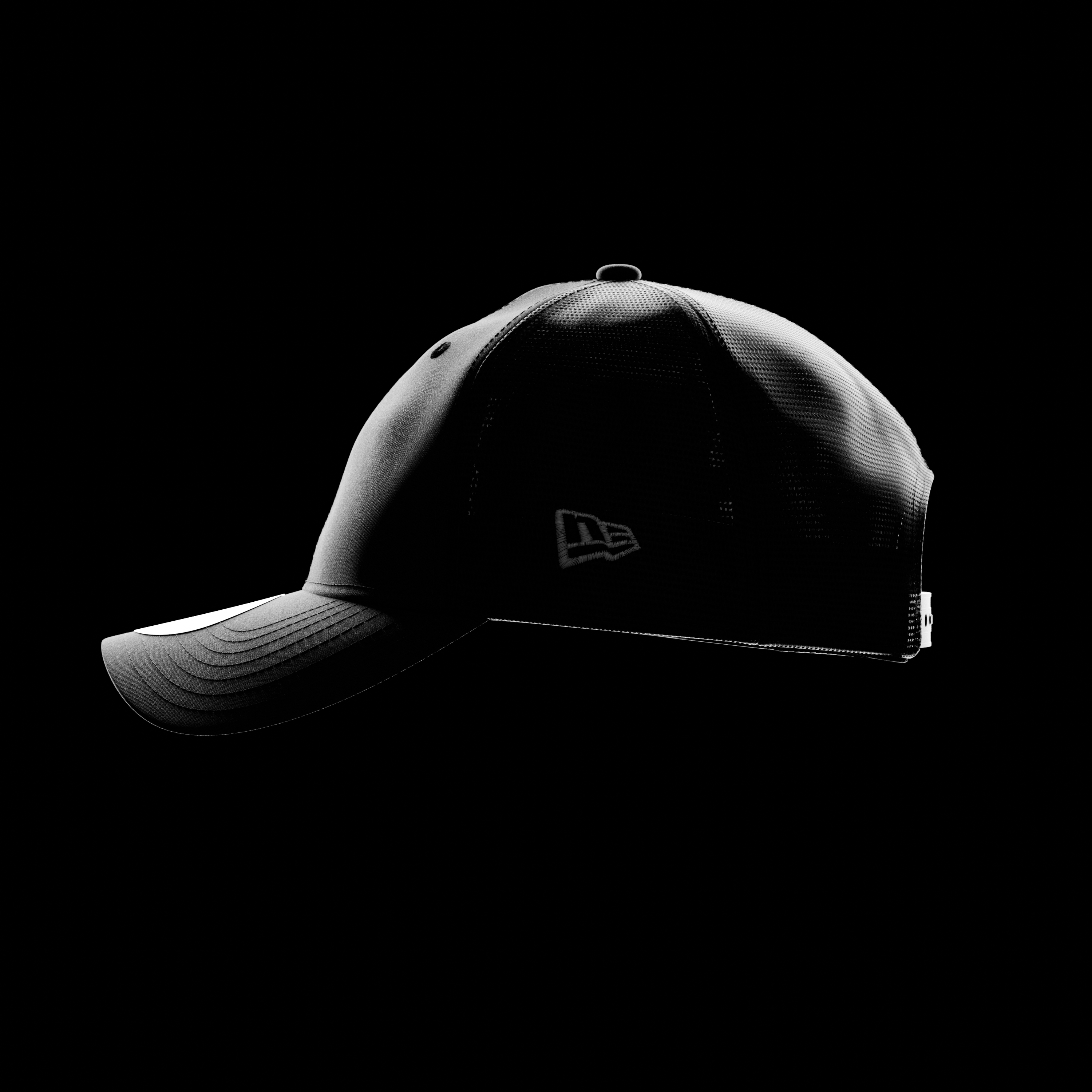 black new era 9twenty trucker cap on a black background