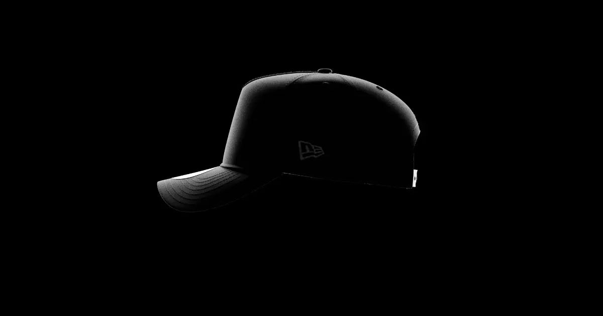 A black baseball cap with a New Era logo on the side.