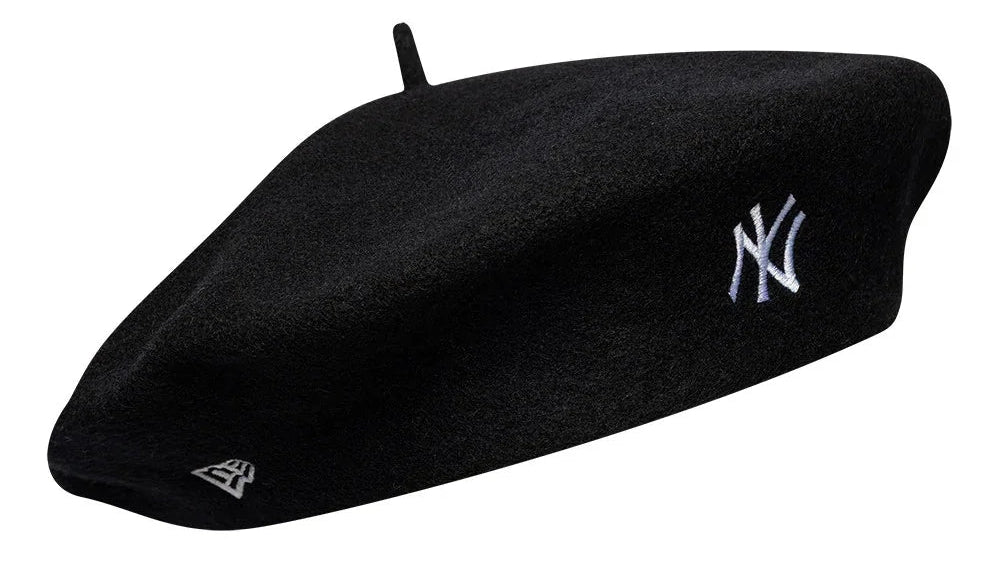 A black New York Yankees beret hat featuring the embroidered white NY logo on the side and a small white New Era logo near the brim, set against a plain white background.