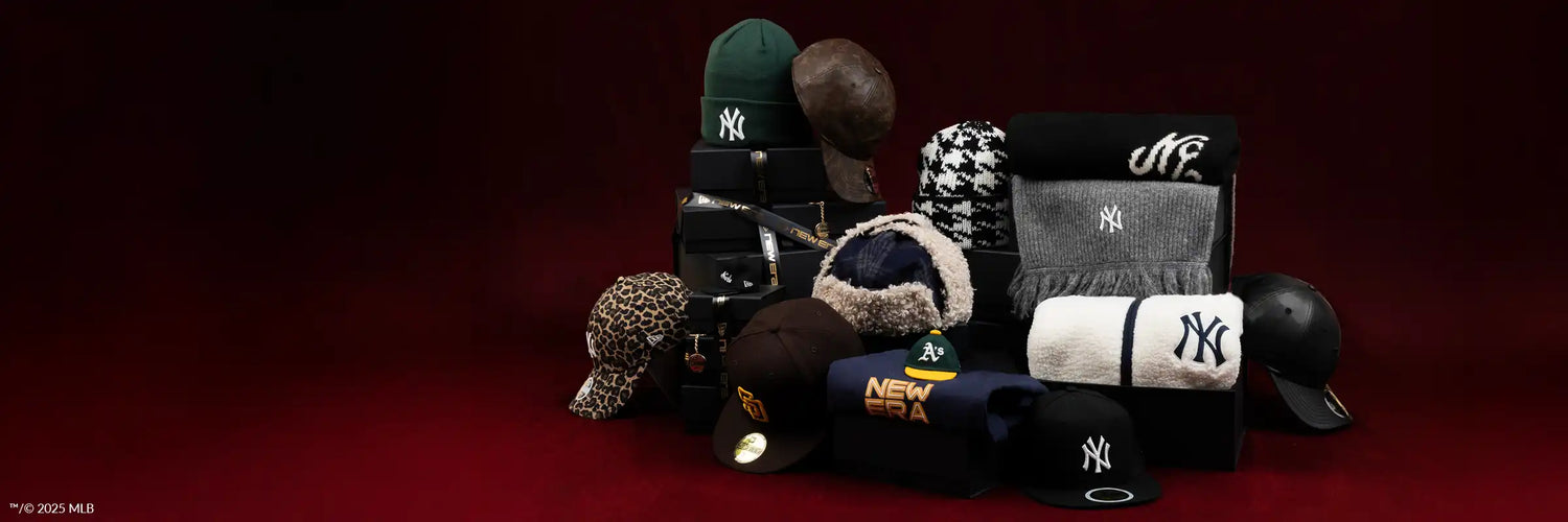 Collection of various caps including Yankees and New Era on a dark red background