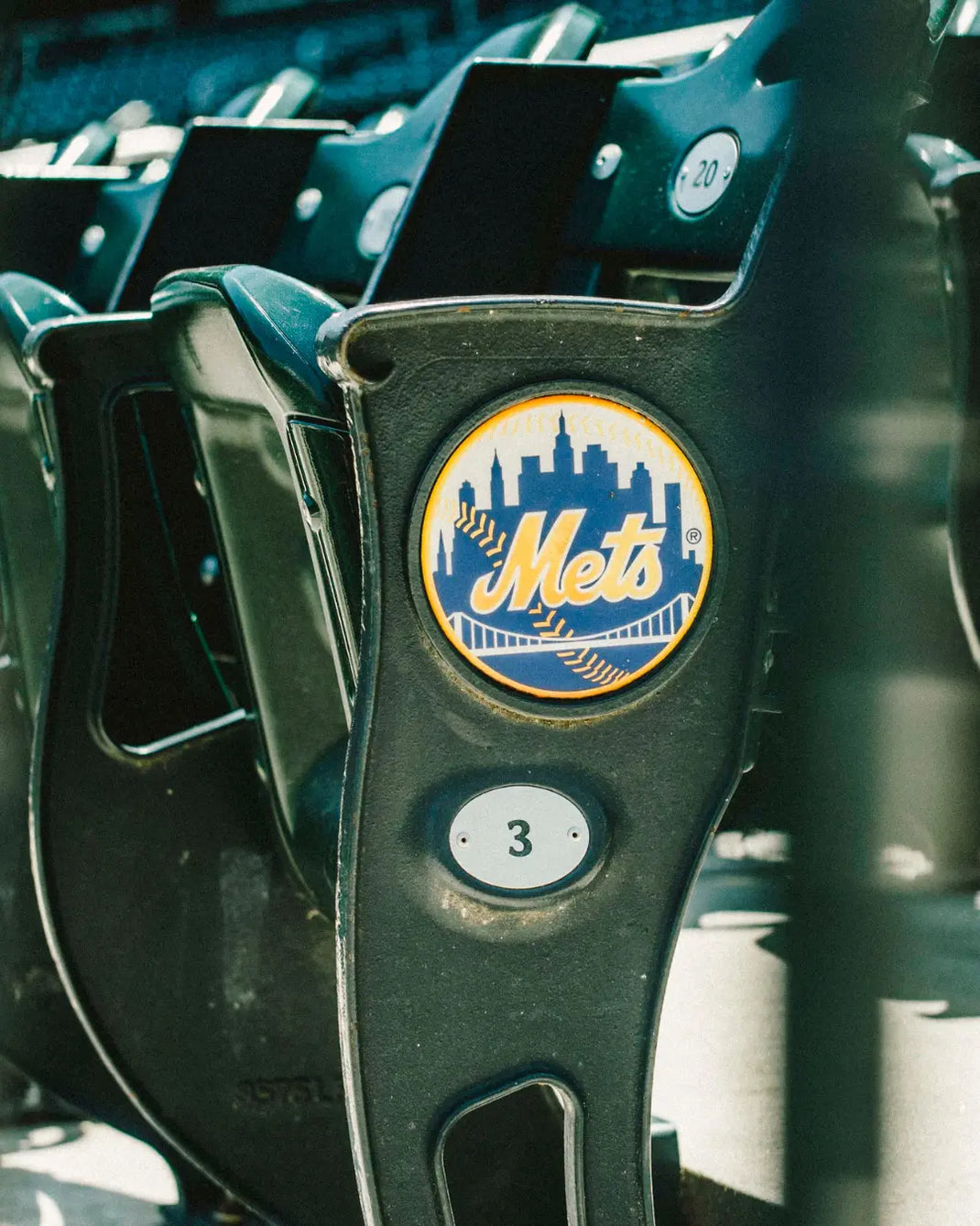 Close-up of a seatback with a Mets logo in a stadium setting