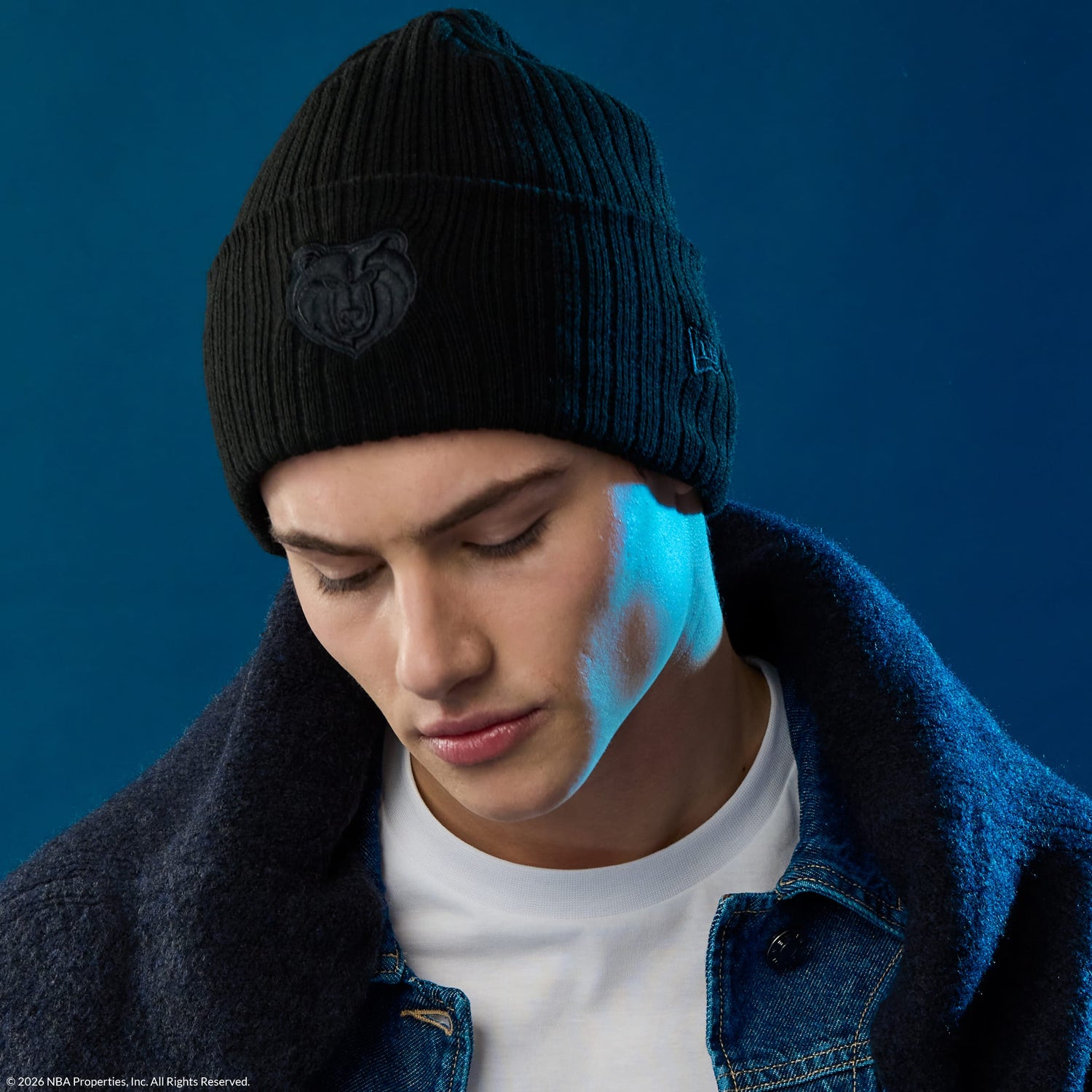 person wearing a black new era NBA knit beanie