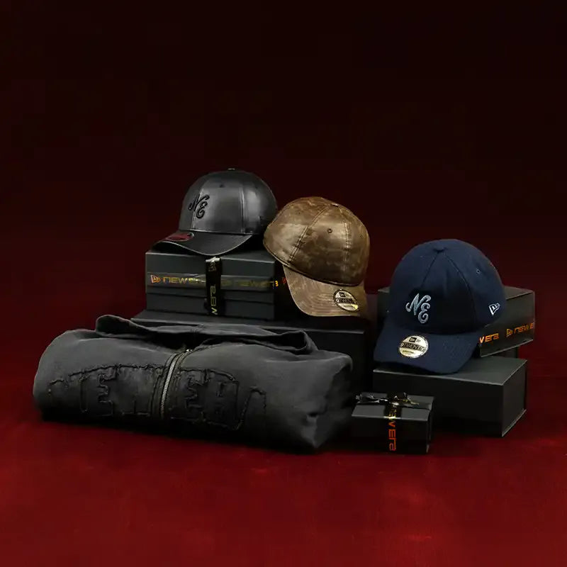Three baseball caps on a red surface with a dark background