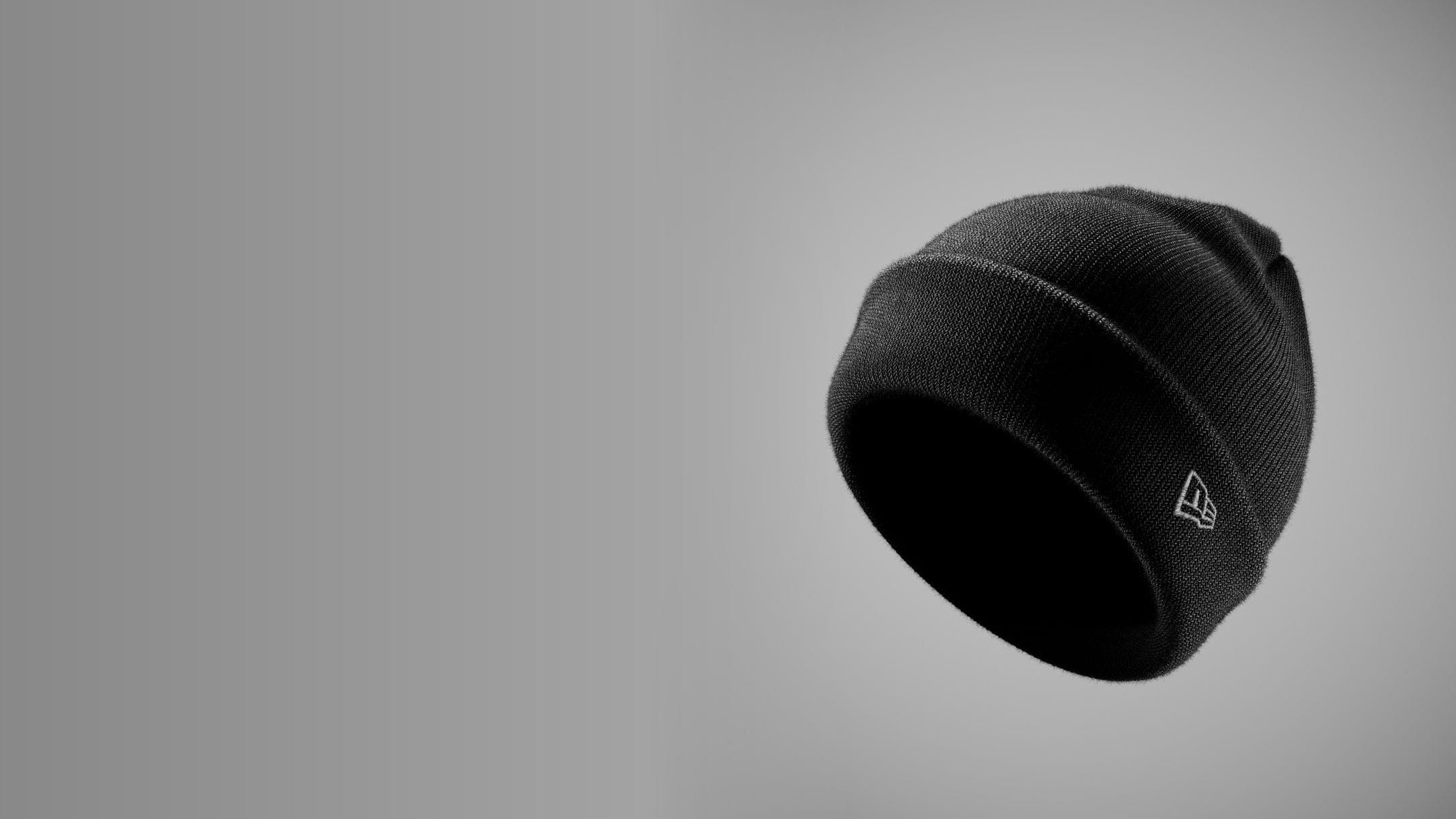 Black beanie with a new era ogo on a gray background