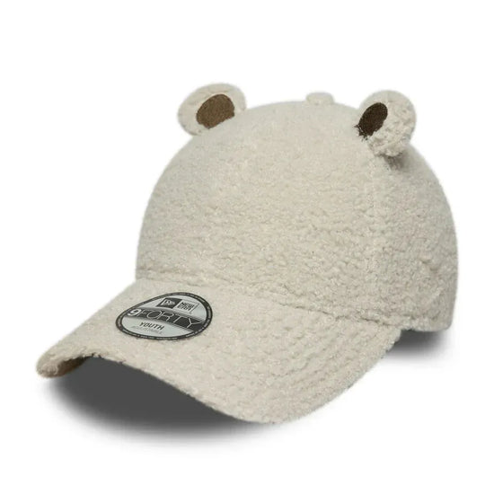 Slide 4:Beige teddy bear-shaped cap on a white background