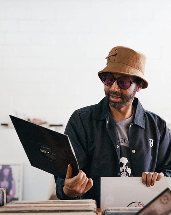 moodymann wearing a new era x moodymann beige bucket hat