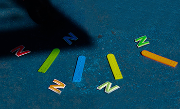 coloured letter and sticks on floor